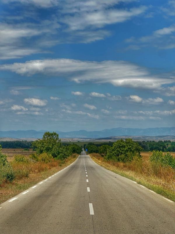 Road vanishing toward mountains