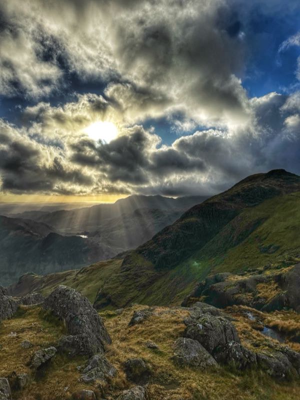 Sunbeams through mountain clouds
